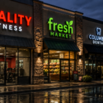Brightly illuminated channel letter signs on a modern Columbus retail storefront at night