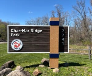 Monument Sign | Wood Grain Sandblasted High Density Urethane (HDU) Sandblasted HDU monument sign with wood grain finish for a public park in Sunbury